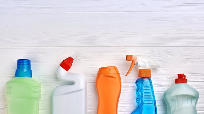 cleaning products lined up on a wooden background